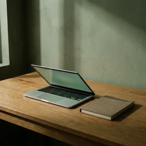 Laptop and notebook on an oak desk